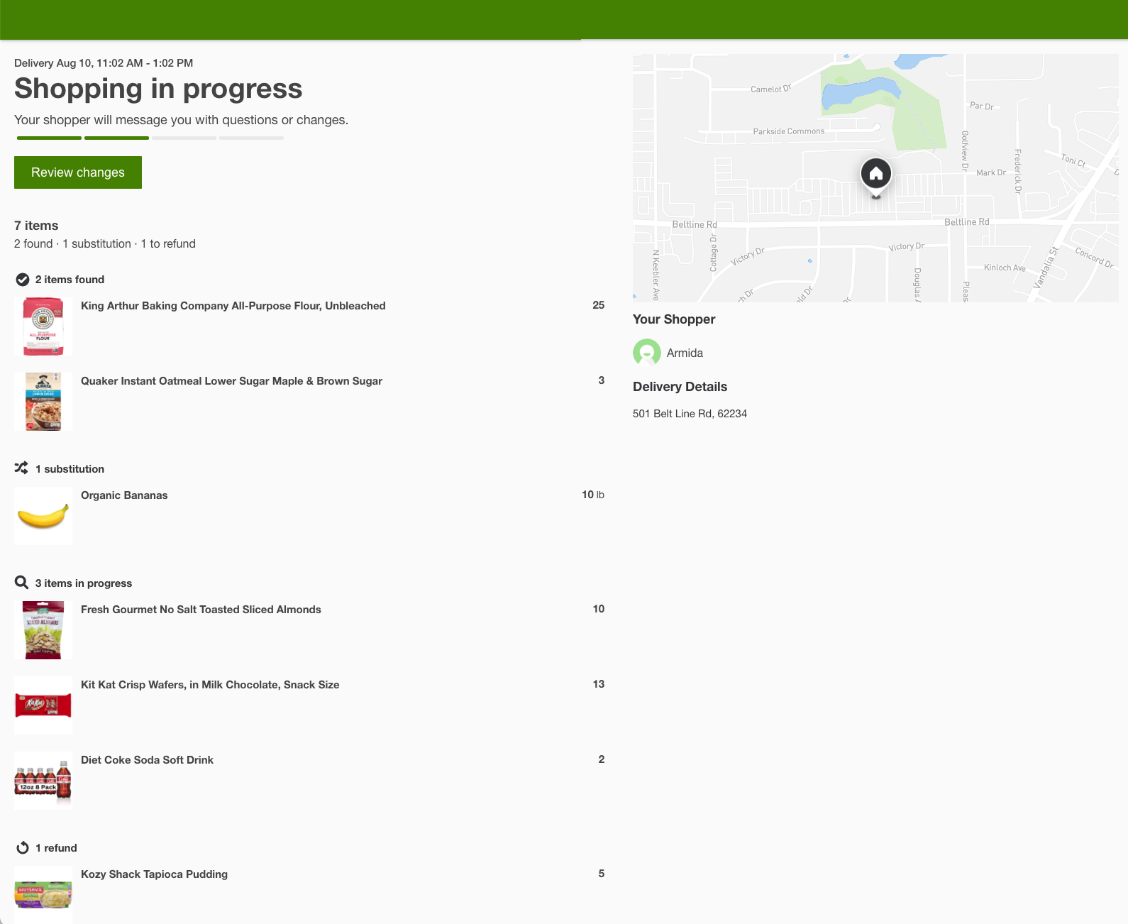 The image shows the Order Status page in a browser view. On the left is the delivery date and time, the Shopping in progress status, and the items in the order with 5 found, 1 replacement, and 1 refund. On the right is the map with both the customer and shopper locations, the shopper&#39;s name Amida, and a delivery address of 501 Belt Line Rd. 62234.